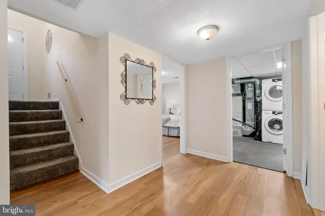 a balcony with wooden floor outdoor seating and yard in the back