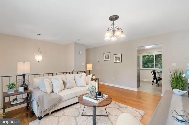 a living room with furniture and a chandelier