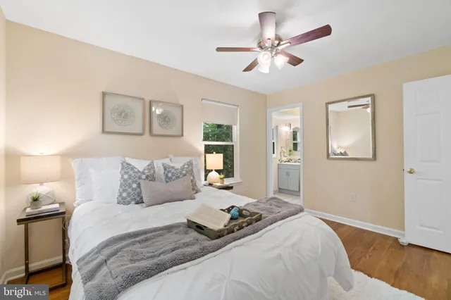 a bedroom with a large bed and a ceiling fan