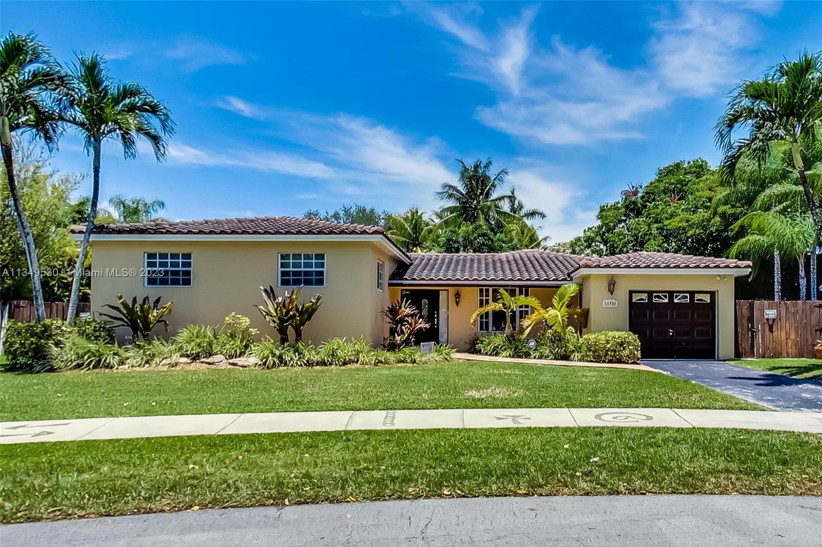 10730 Southwest 106th Avenue Miami, FL 33176 - Photo 1 of 45 a front view of a house with a yard and garage
