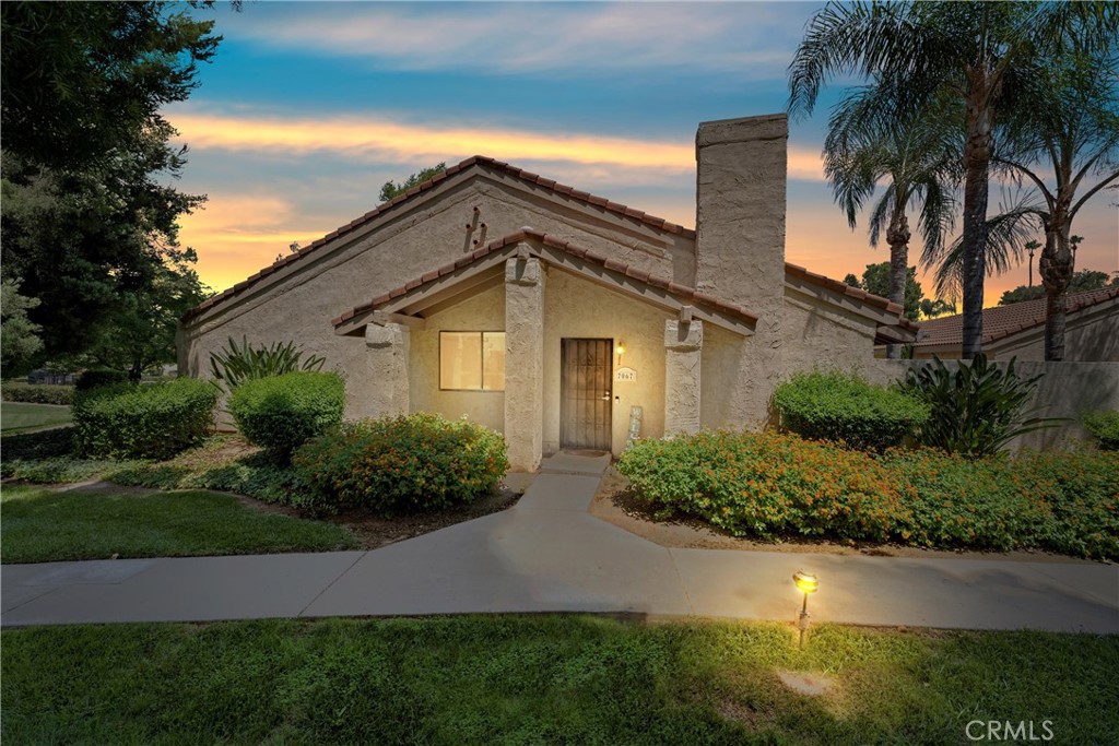 7067 Seville Way Riverside, CA 92504 - Photo 1 of 1 a front view of house with yard and green space