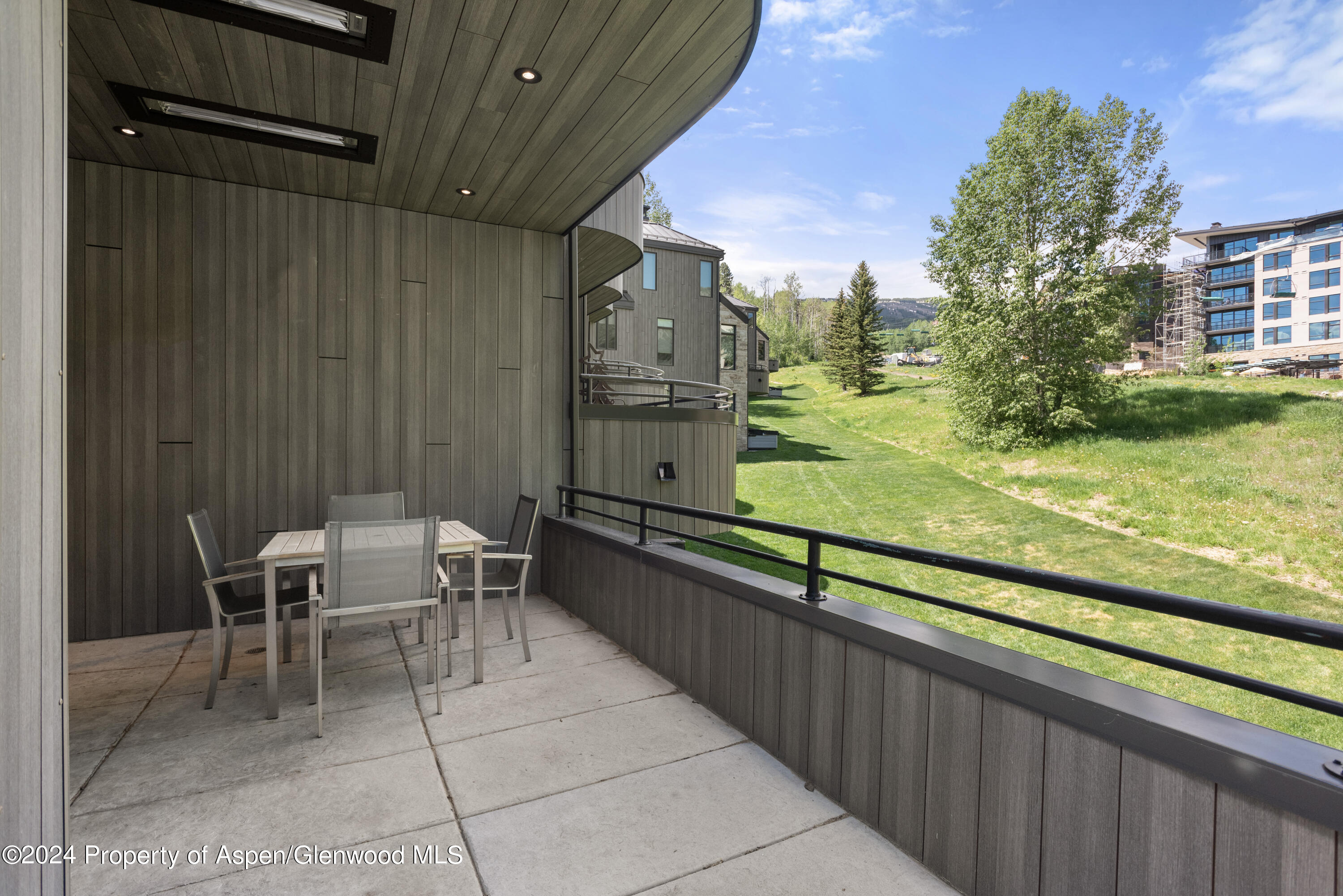 381 Ridge Road, Unit C4 Snowmass Village, CO 81615 - Photo 13 of 43 a view of a chairs and table in patio with a yard