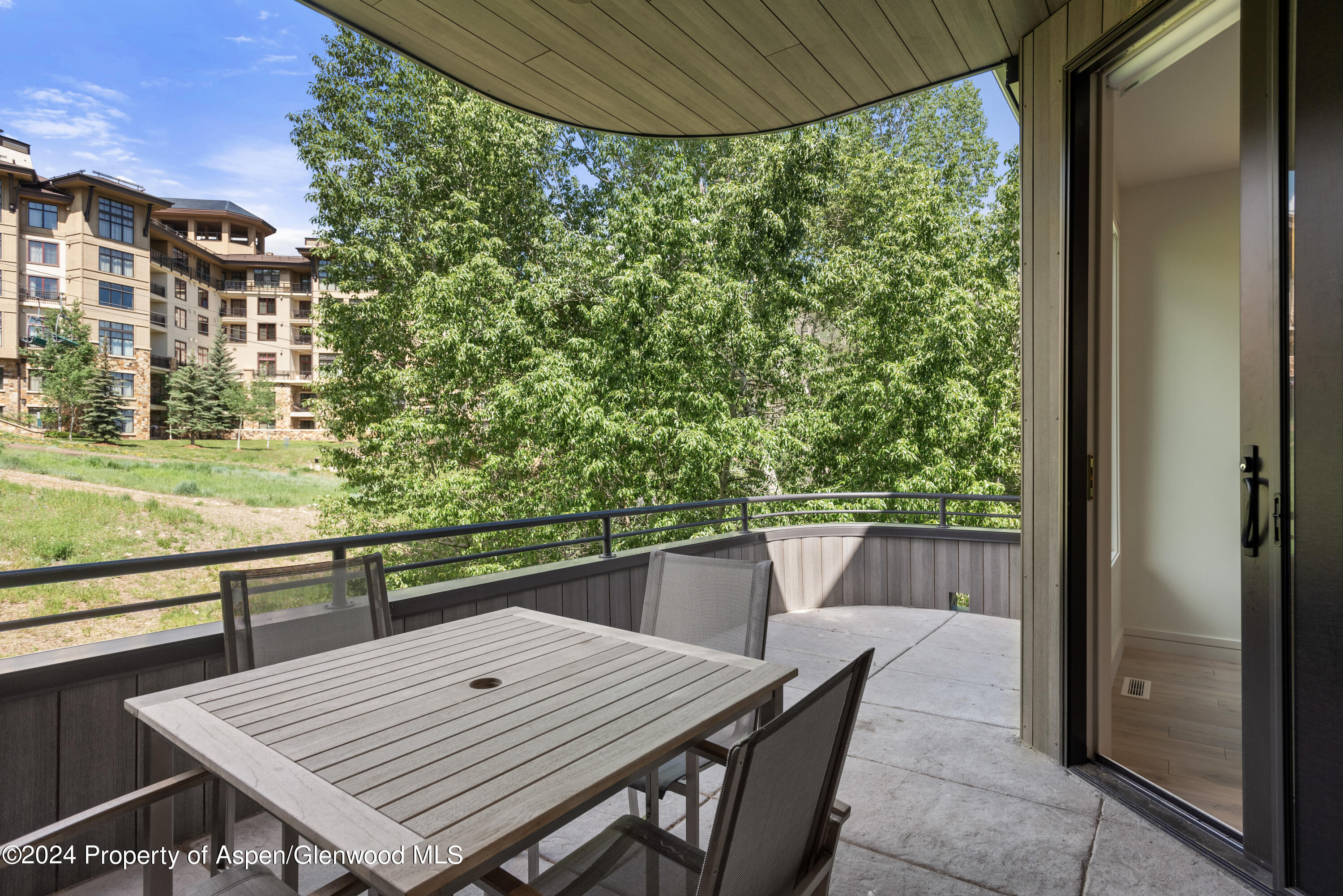 381 Ridge Road, Unit C4 Snowmass Village, CO 81615 - Photo 14 of 43 a view of a balcony with table and chairs and potted plants