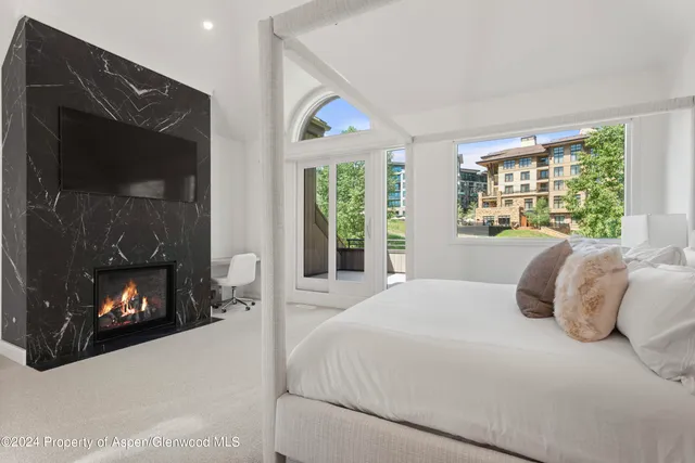 a bedroom with a bed and a fireplace