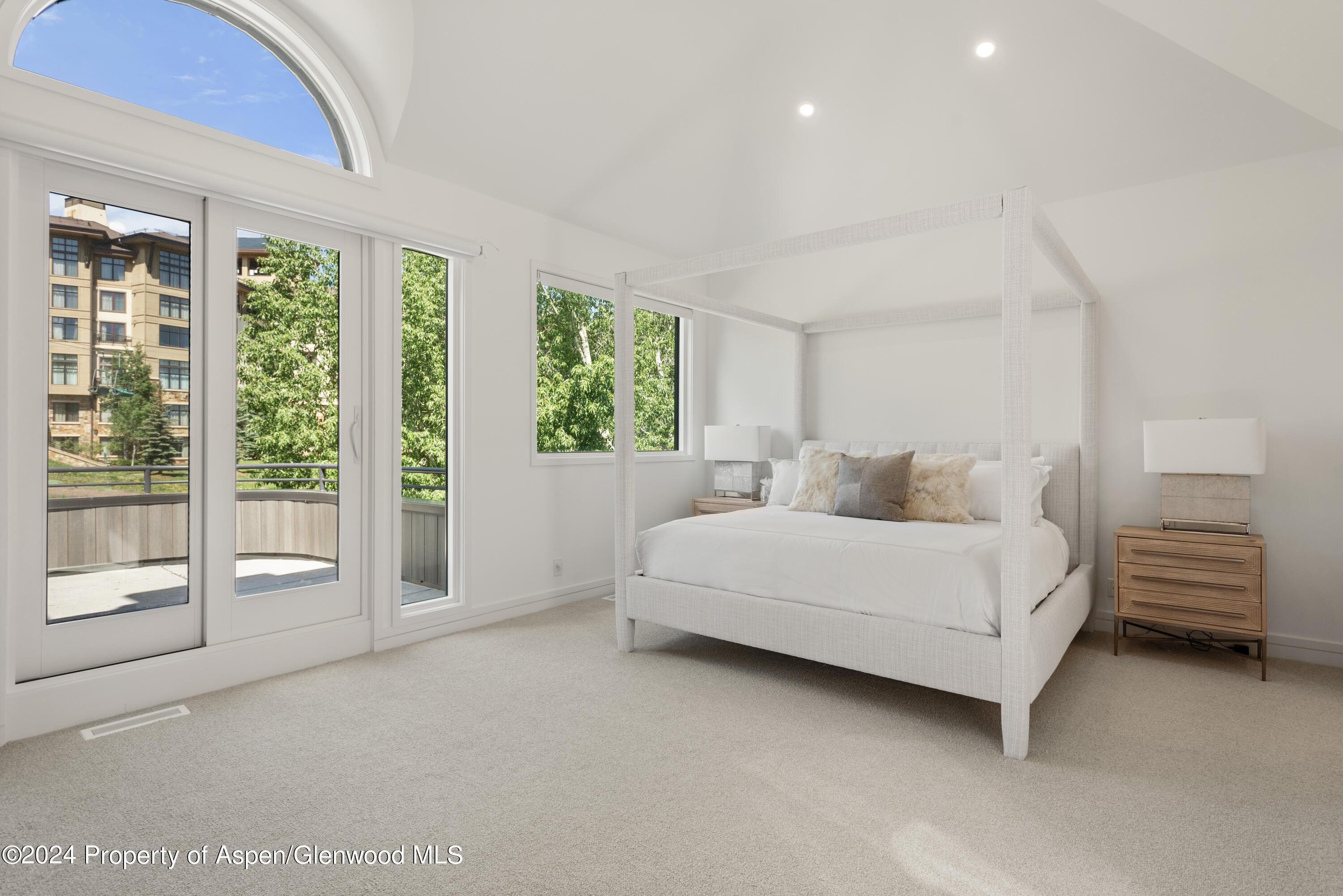 381 Ridge Road, Unit C4 Snowmass Village, CO 81615 - Photo 19 of 43 a spacious bedroom with a bed and a large window