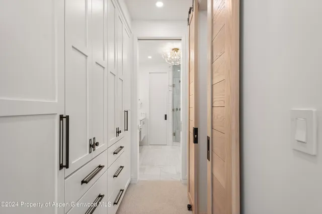 a bathroom with a glass door shower and a sink