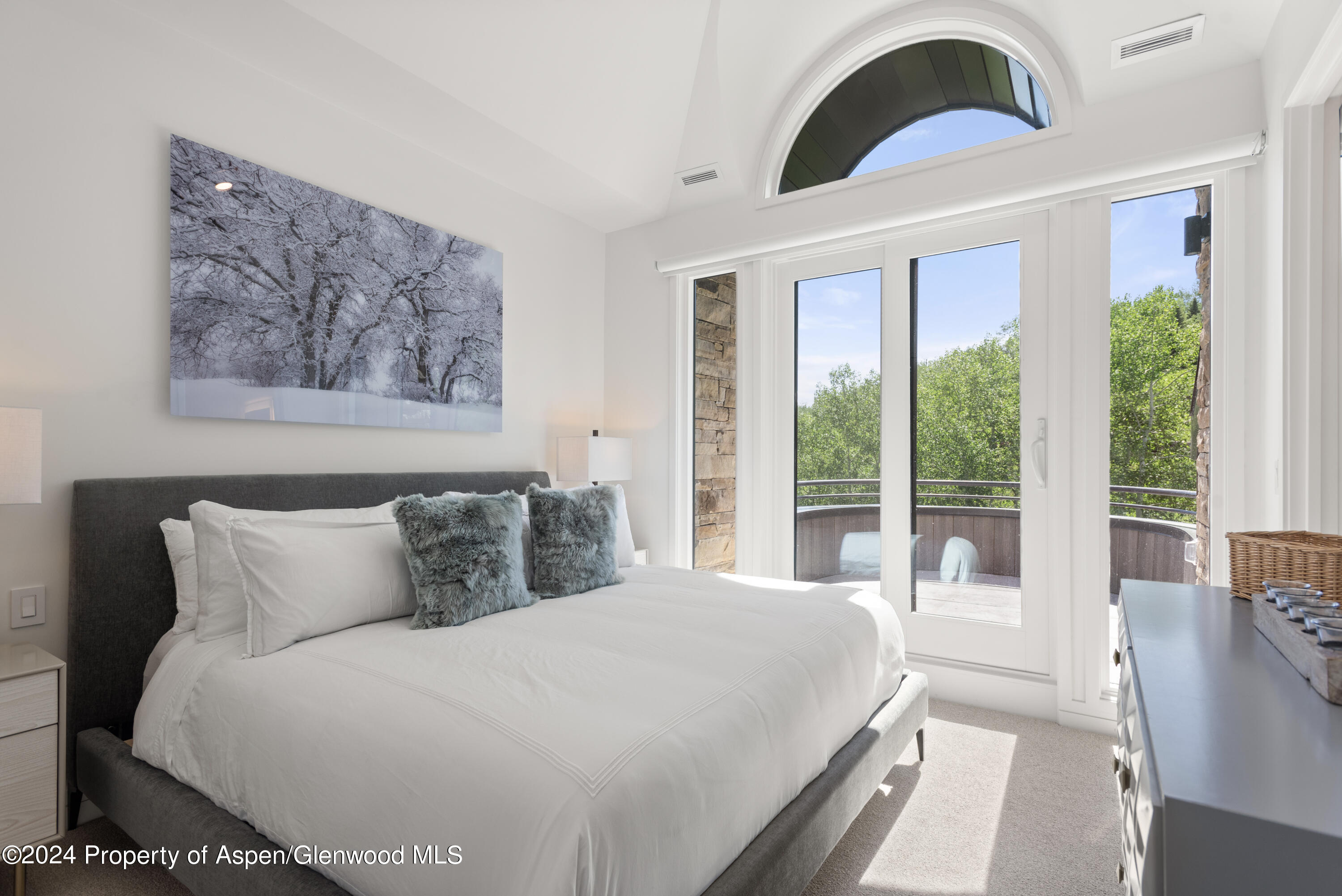 381 Ridge Road, Unit C4 Snowmass Village, CO 81615 - Photo 24 of 43 a bedroom with a large bed and a large window