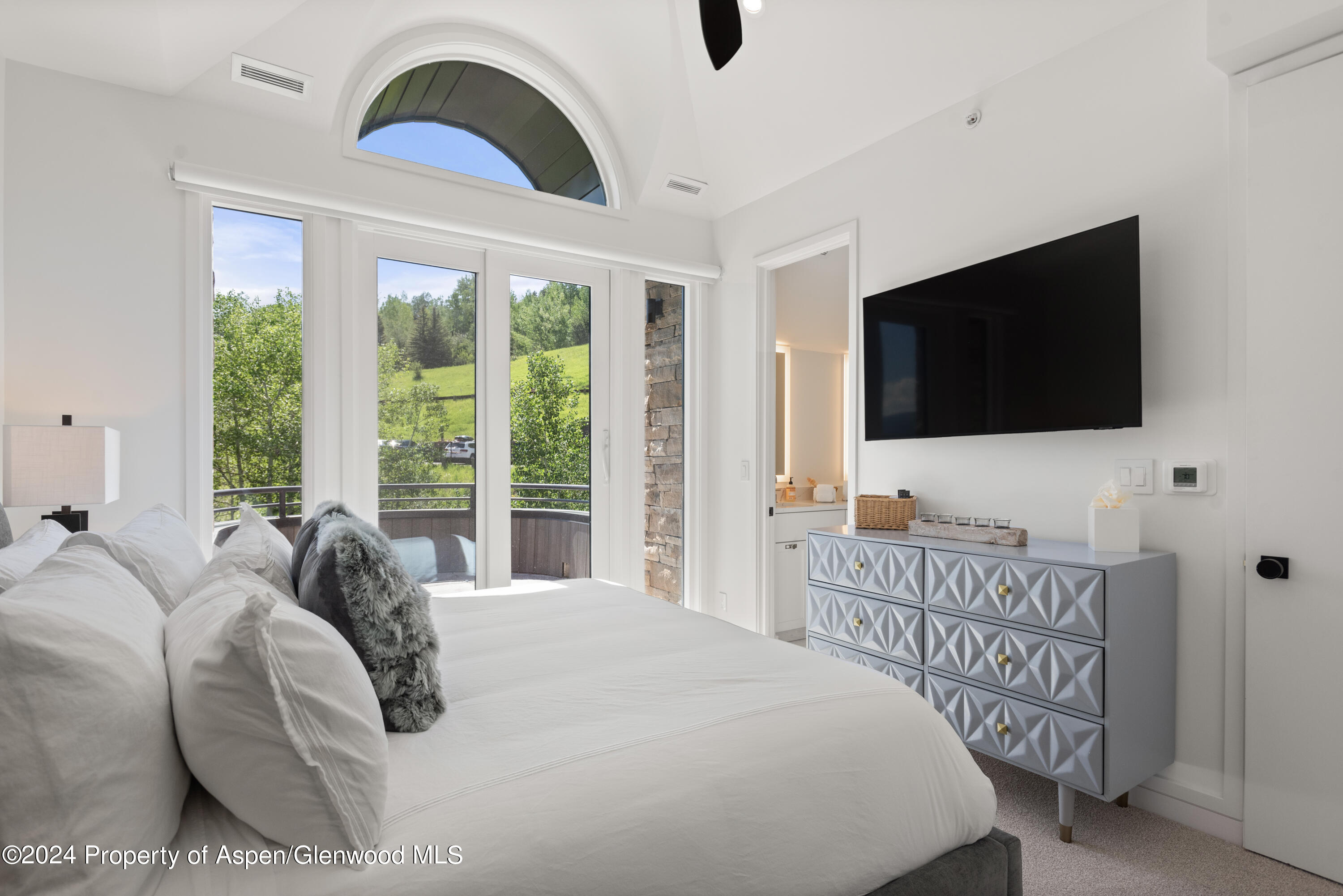 381 Ridge Road, Unit C4 Snowmass Village, CO 81615 - Photo 25 of 43 a bedroom with a bed and a flat screen tv