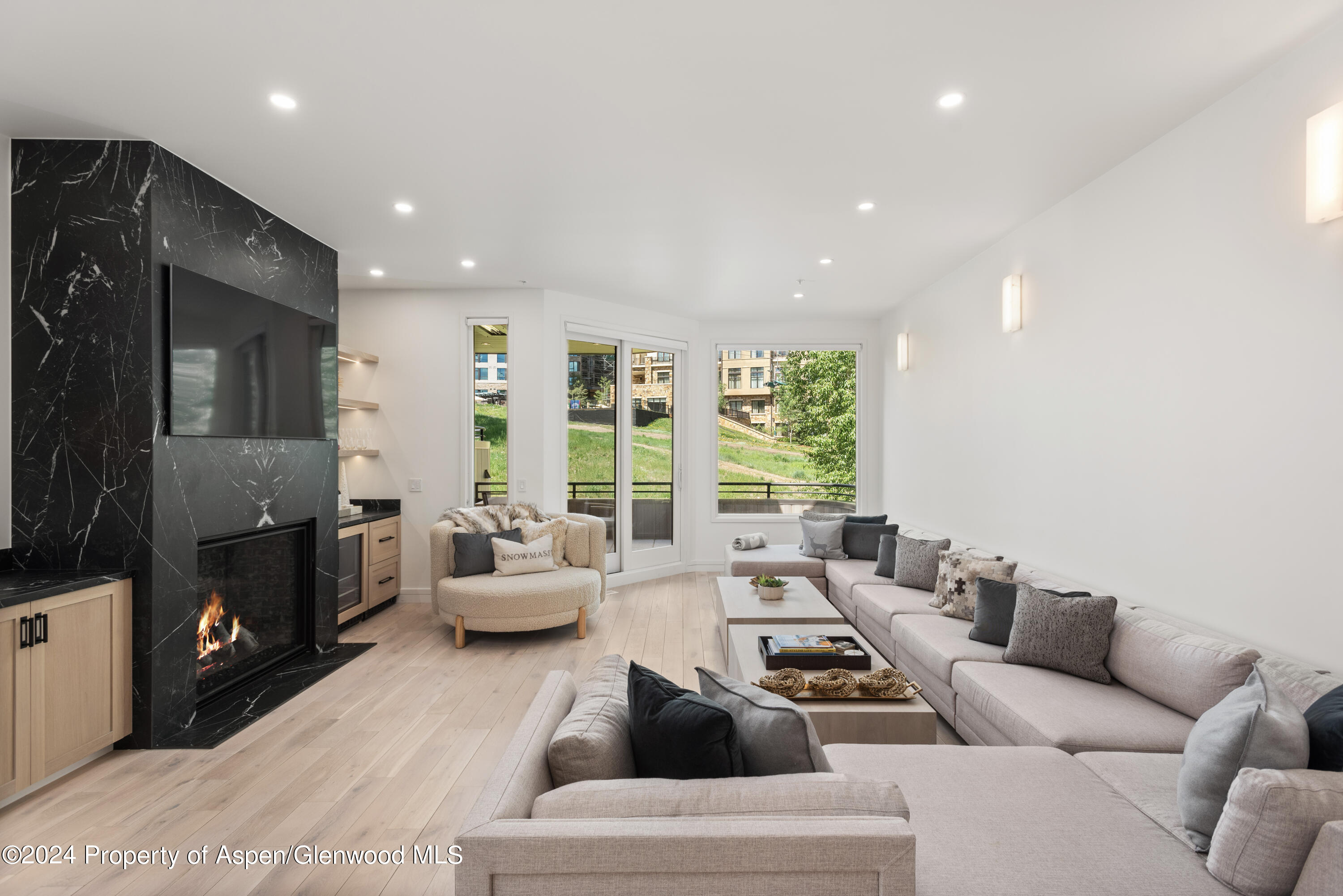 381 Ridge Road, Unit C4 Snowmass Village, CO 81615 - Photo 3 of 43 a living room with furniture and a flat screen tv