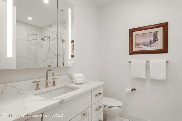 a living room with furniture and a wall painting