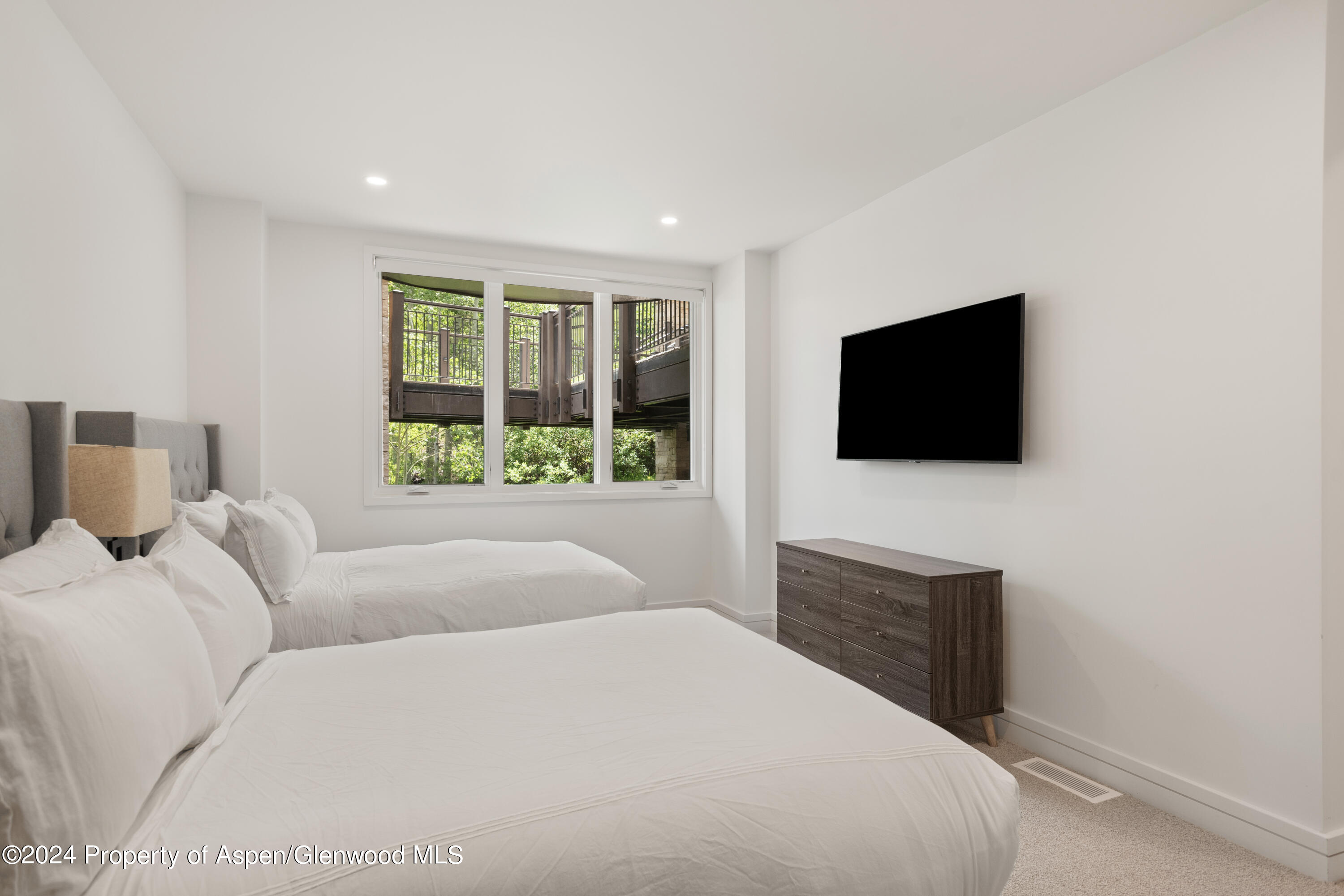 381 Ridge Road, Unit C4 Snowmass Village, CO 81615 - Photo 33 of 43 a living room with a flat screen tv a window and a flat screen tv