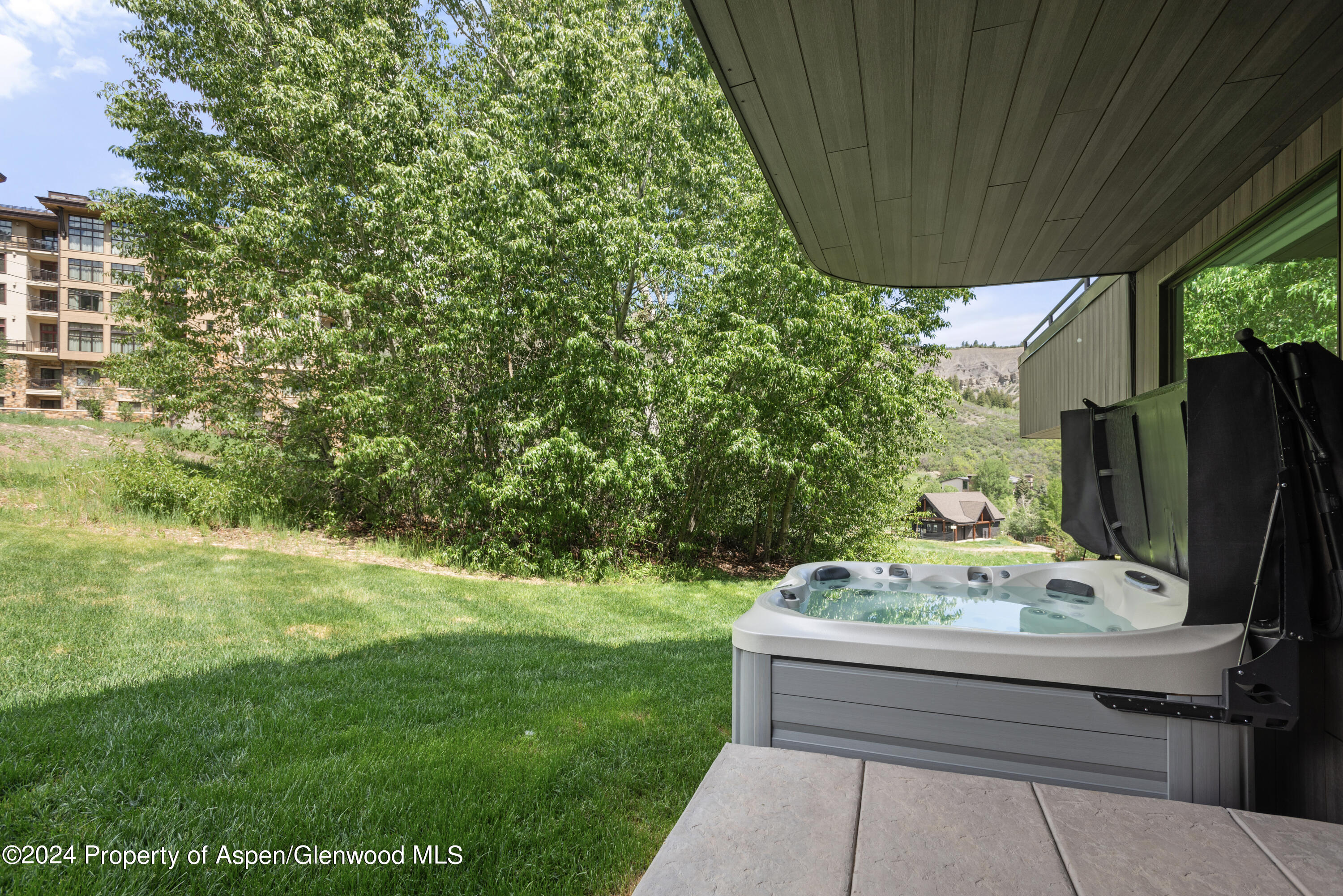381 Ridge Road, Unit C4 Snowmass Village, CO 81615 - Photo 36 of 43 a backyard of a house with table and chairs