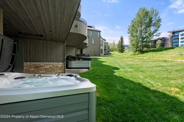 a front view of a house with a garden and trees