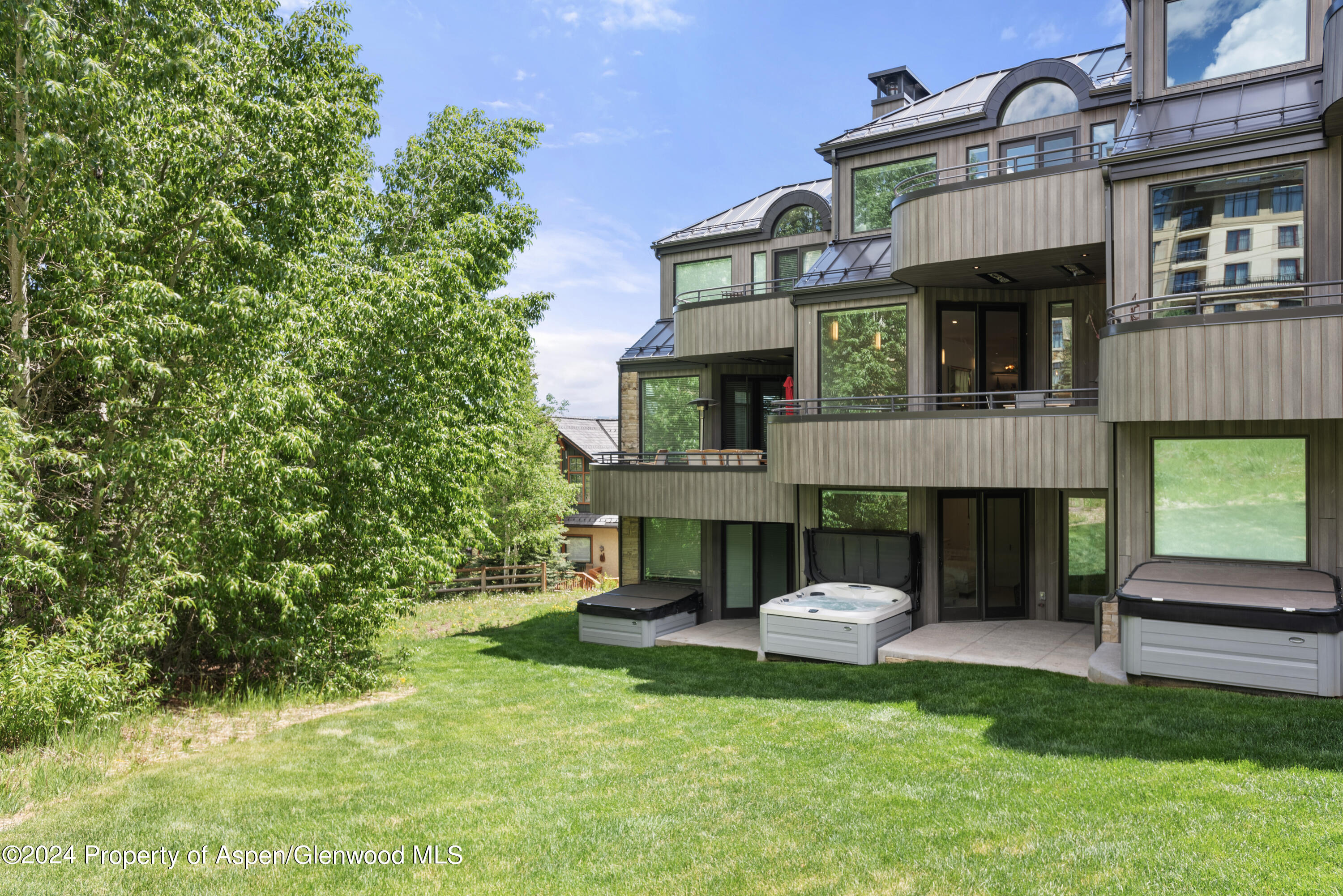 381 Ridge Road, Unit C4 Snowmass Village, CO 81615 - Photo 38 of 43 a front view of a house with a garden and trees