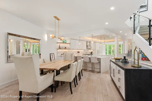 a large kitchen with a table and chairs