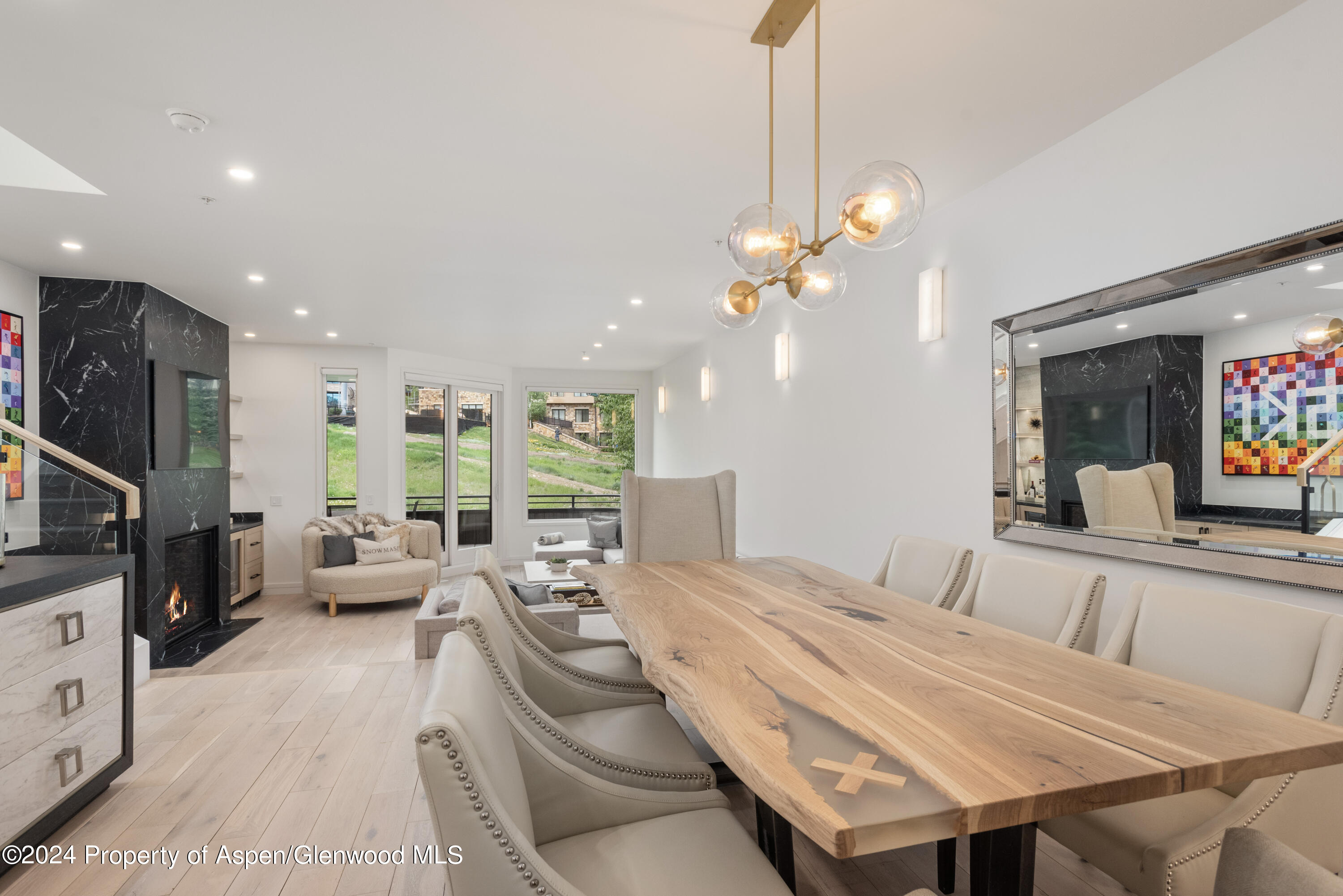 381 Ridge Road, Unit C4 Snowmass Village, CO 81615 - Photo 6 of 43 a bedroom with a bed a large window and flat screen tv