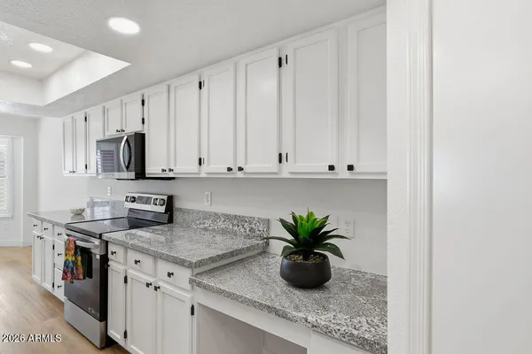 a kitchen with a sink a stove and cabinets