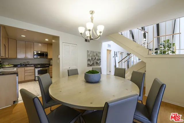 a view of a dining room with furniture and a chandelier