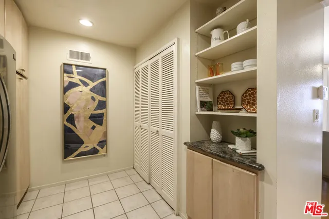 a kitchen with a refrigerator and cabinets