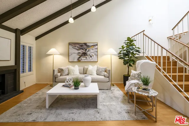 a living room with furniture rug and wooden floor