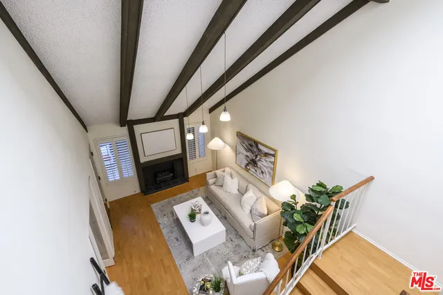 a view of living room with furniture and a fireplace