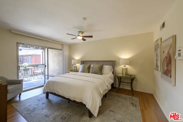 a bedroom with a bed lamps and window