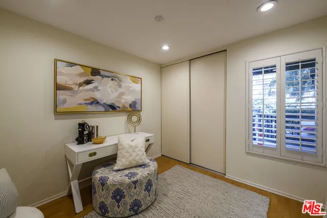 a hallway with a baby crib and a couch