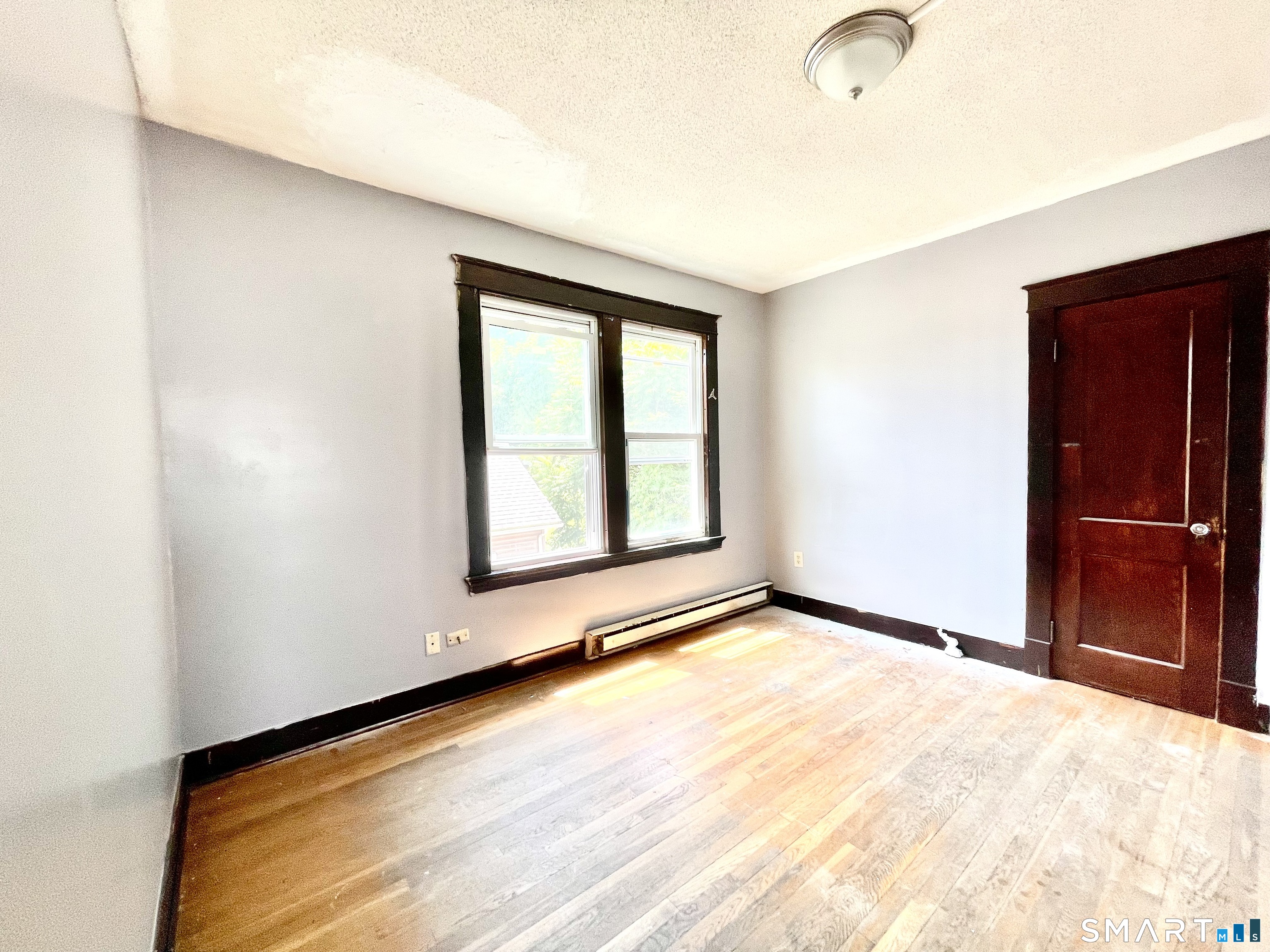 146 Charles Street, Unit 3 Waterbury, CT 06708 - Photo 14 of 20 an empty room with windows