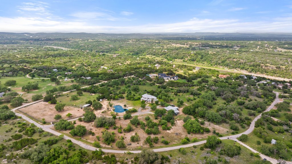 an aerial view of residential houses with outdoor space