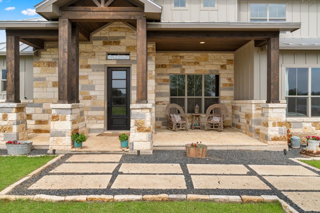 3830 Outback Trail Spicewood, TX 78669 - Photo 11 of 40 a front view of a house with a patio