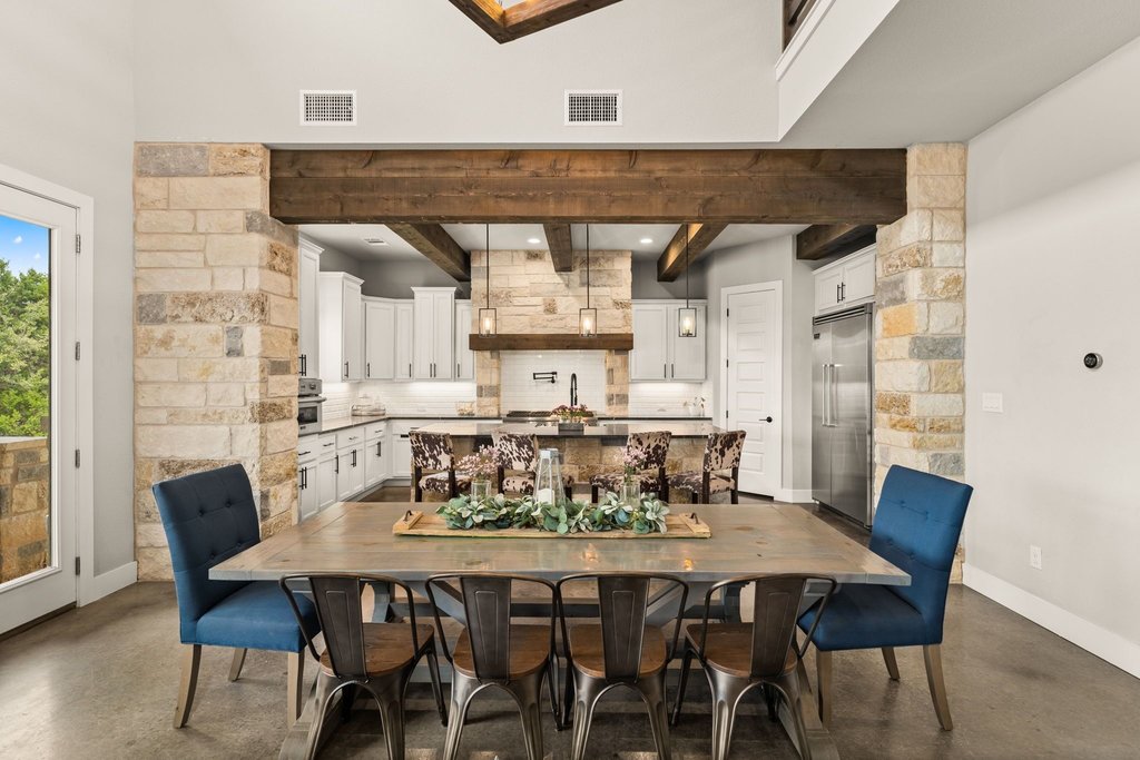 3830 Outback Trail Spicewood, TX 78669 - Photo 19 of 40 a view of a dining room with furniture and wooden floor