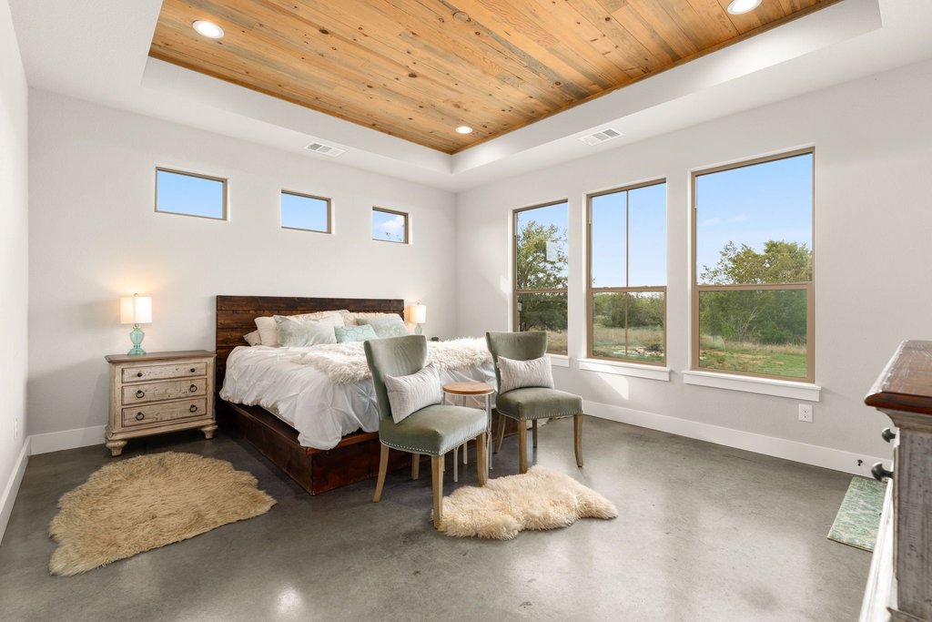 3830 Outback Trail Spicewood, TX 78669 - Photo 22 of 40 a bed room with a bed and a large window