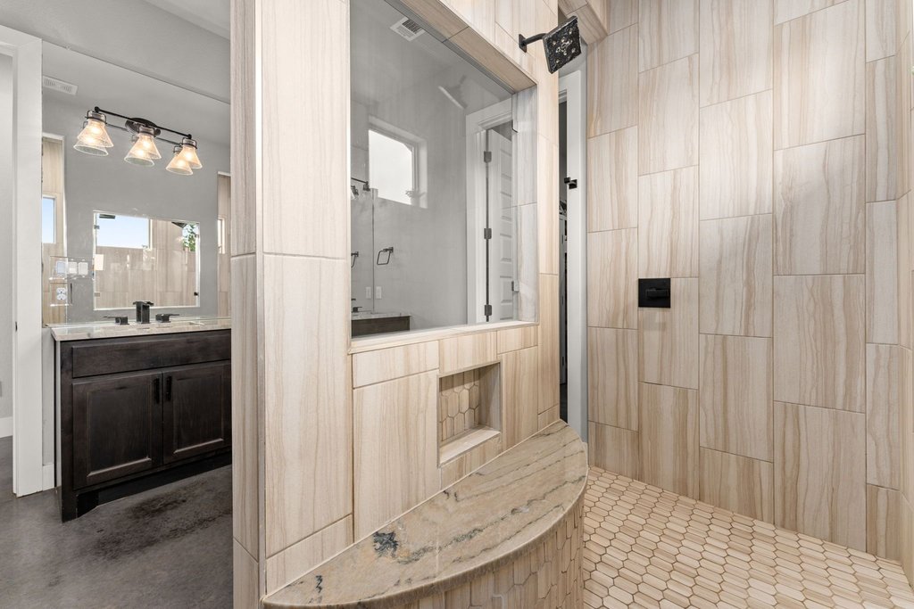 3830 Outback Trail Spicewood, TX 78669 - Photo 24 of 40 a bathroom with a sink and a mirror
