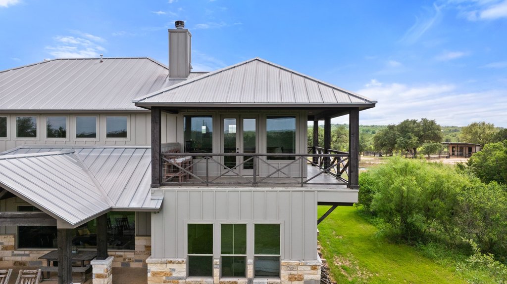 3830 Outback Trail Spicewood, TX 78669 - Photo 28 of 40 a front view of a house with garden