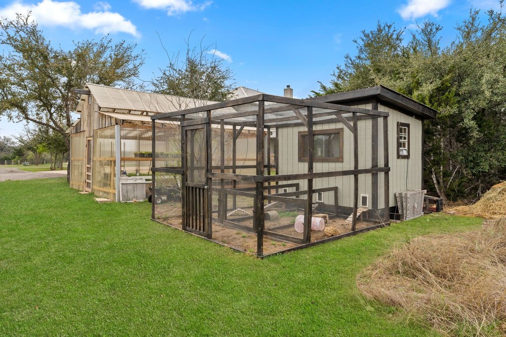 3830 Outback Trail Spicewood, TX 78669 - Photo 32 of 40 a view of a house with a yard