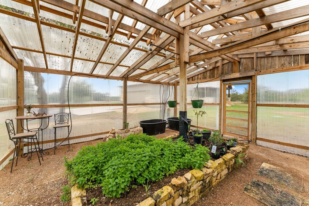 3830 Outback Trail Spicewood, TX 78669 - Photo 33 of 40 a garden view with a sitting space
