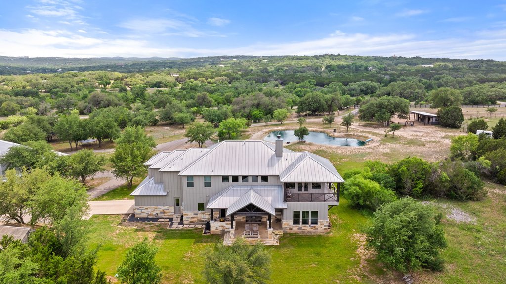 3830 Outback Trail Spicewood, TX 78669 - Photo 8 of 40 an aerial view of a house with swimming pool garden and mountain view