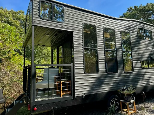 a living room with furniture a rug and a window