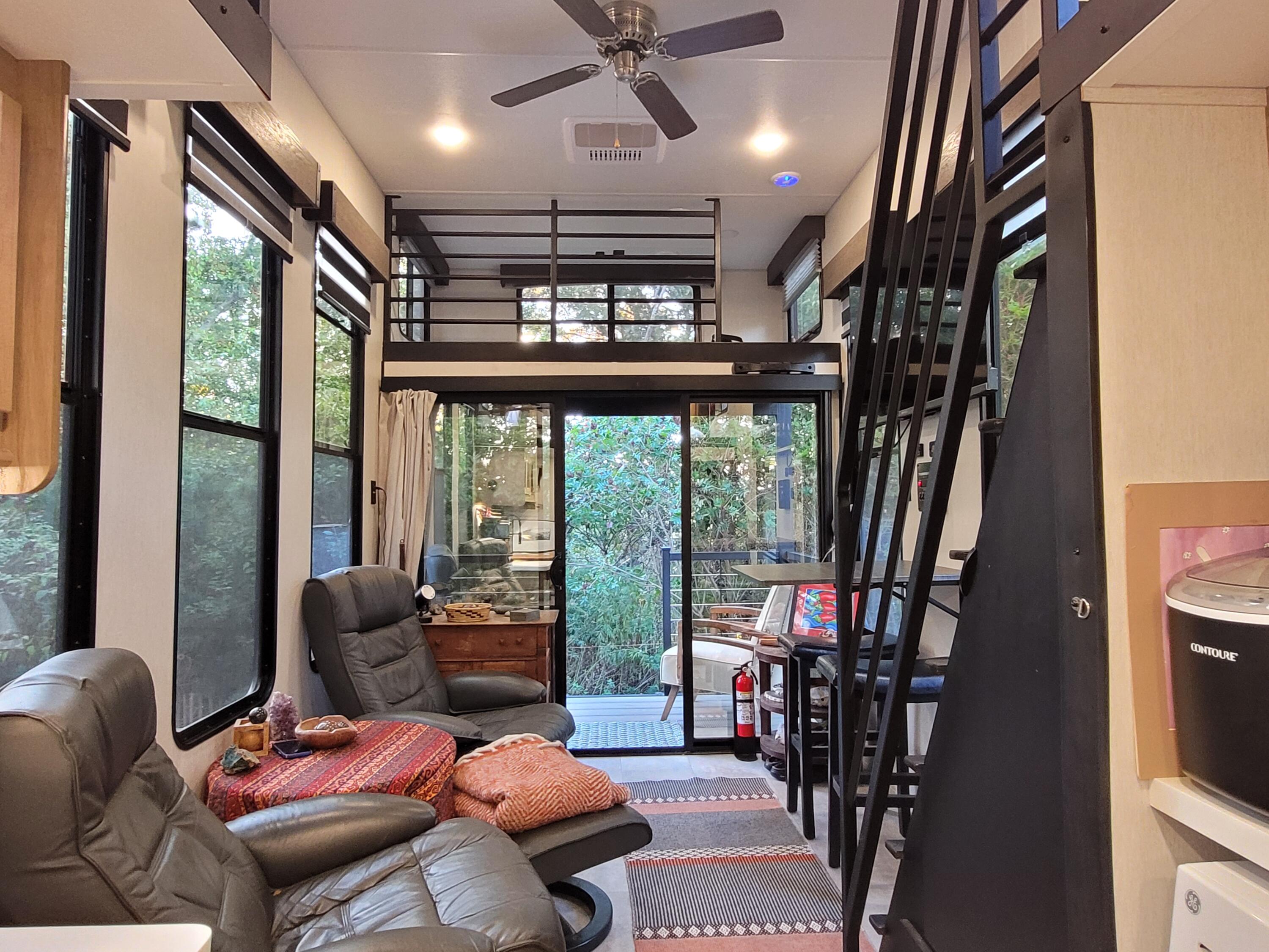 71 South Highland Road, Unit 235 Truro, MA 02666 - Photo 66 of 74 a living room with furniture a floor to ceiling window and a flat screen tv