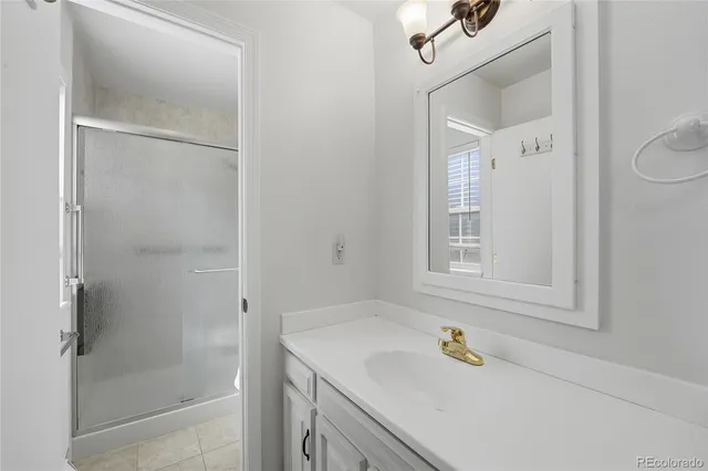 a bathroom with a granite countertop sink a toilet and shower