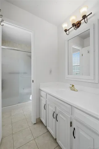 a bathroom with a shower and a sink