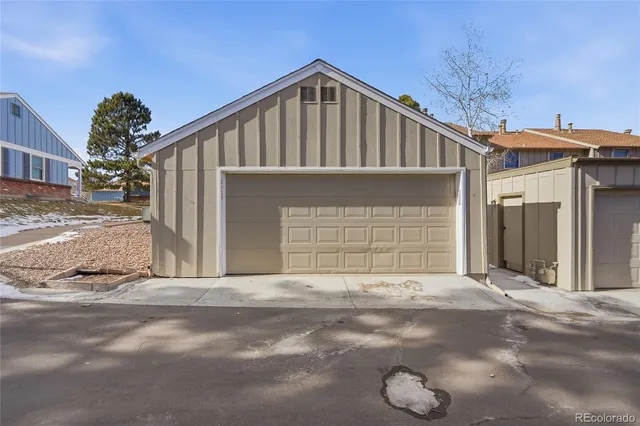 a view of a house with a garage and yard