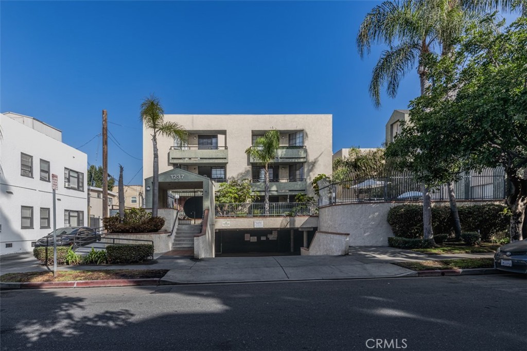 1237 East 6th Street, Unit 110 Long Beach, CA 90802 - Photo 1 of 22 a front view of a house with a yard