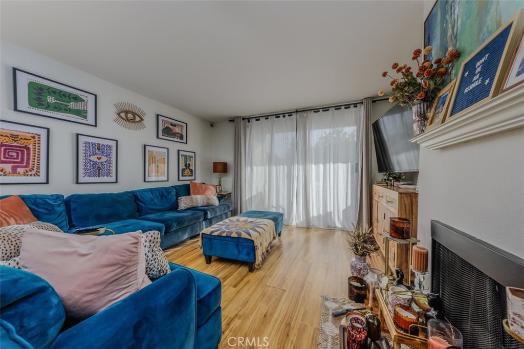 1237 East 6th Street, Unit 110 Long Beach, CA 90802 - Photo 3 of 22 a living room with furniture and a flat screen tv