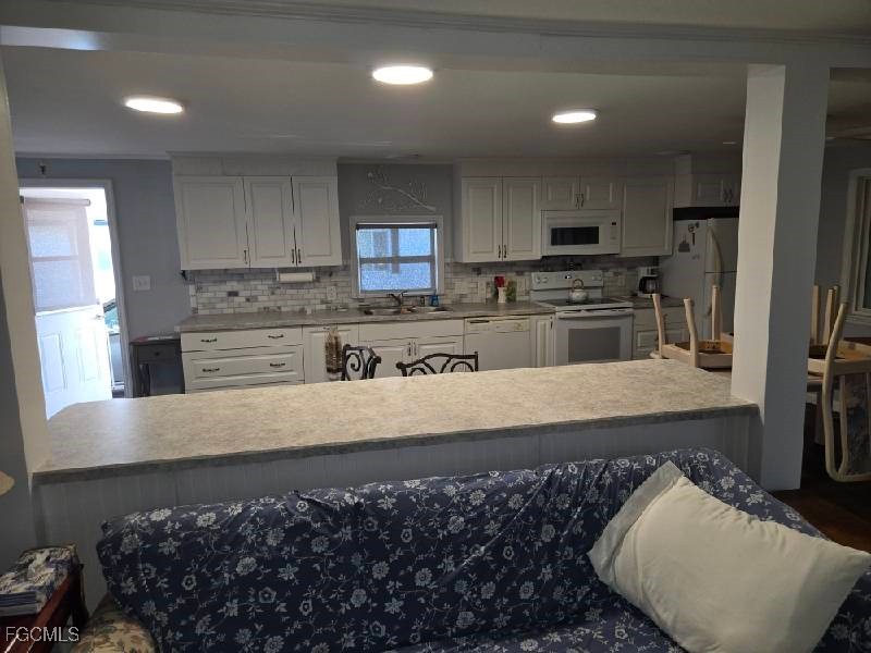 9 Elder Alva, FL 33920 - Photo 12 of 12 a kitchen with stainless steel appliances granite countertop a sink stove and refrigerator