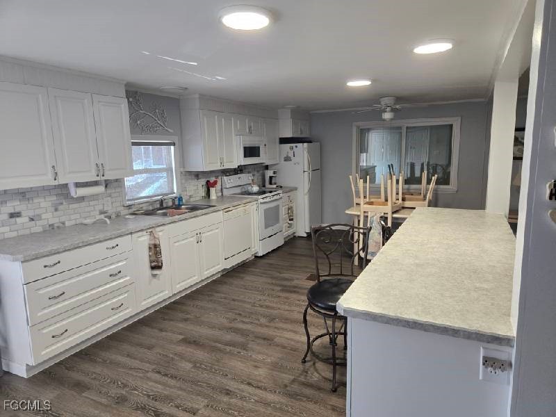 9 Elder Alva, FL 33920 - Photo 2 of 12 a large kitchen with kitchen island a sink stainless steel appliances and cabinets