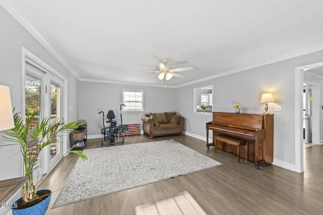 a living room with furniture and a piano