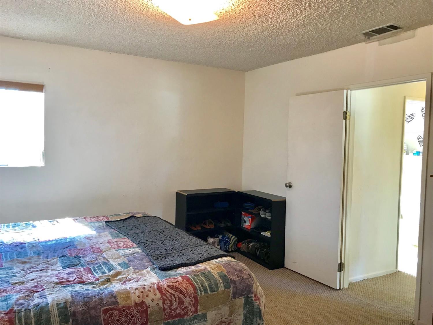 160 Grapevine Road Oak View, CA 93022 - Photo 15 of 35 a bedroom with a bed and a fireplace