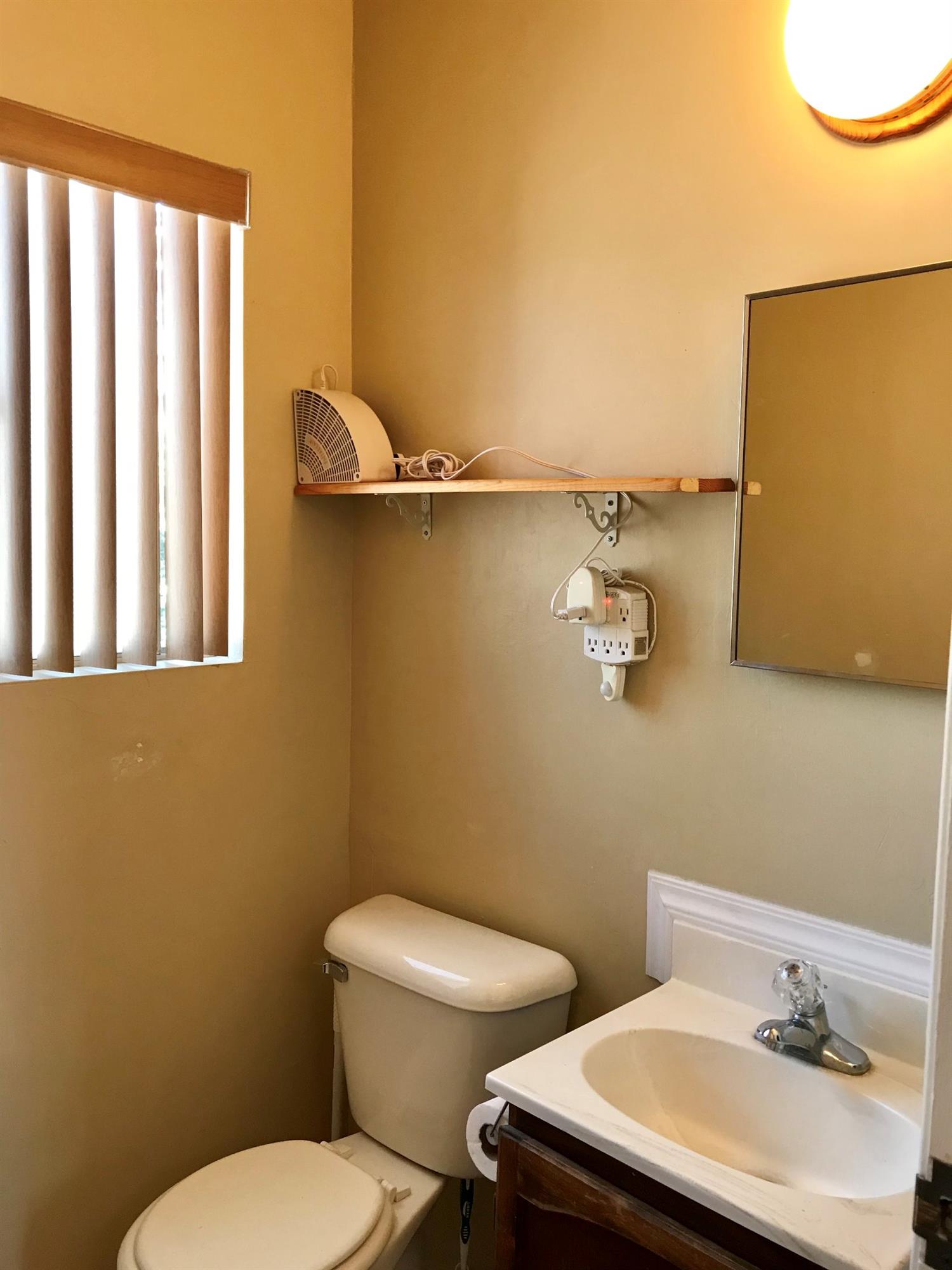 160 Grapevine Road Oak View, CA 93022 - Photo 18 of 35 a bathroom with a sink mirror and toilet