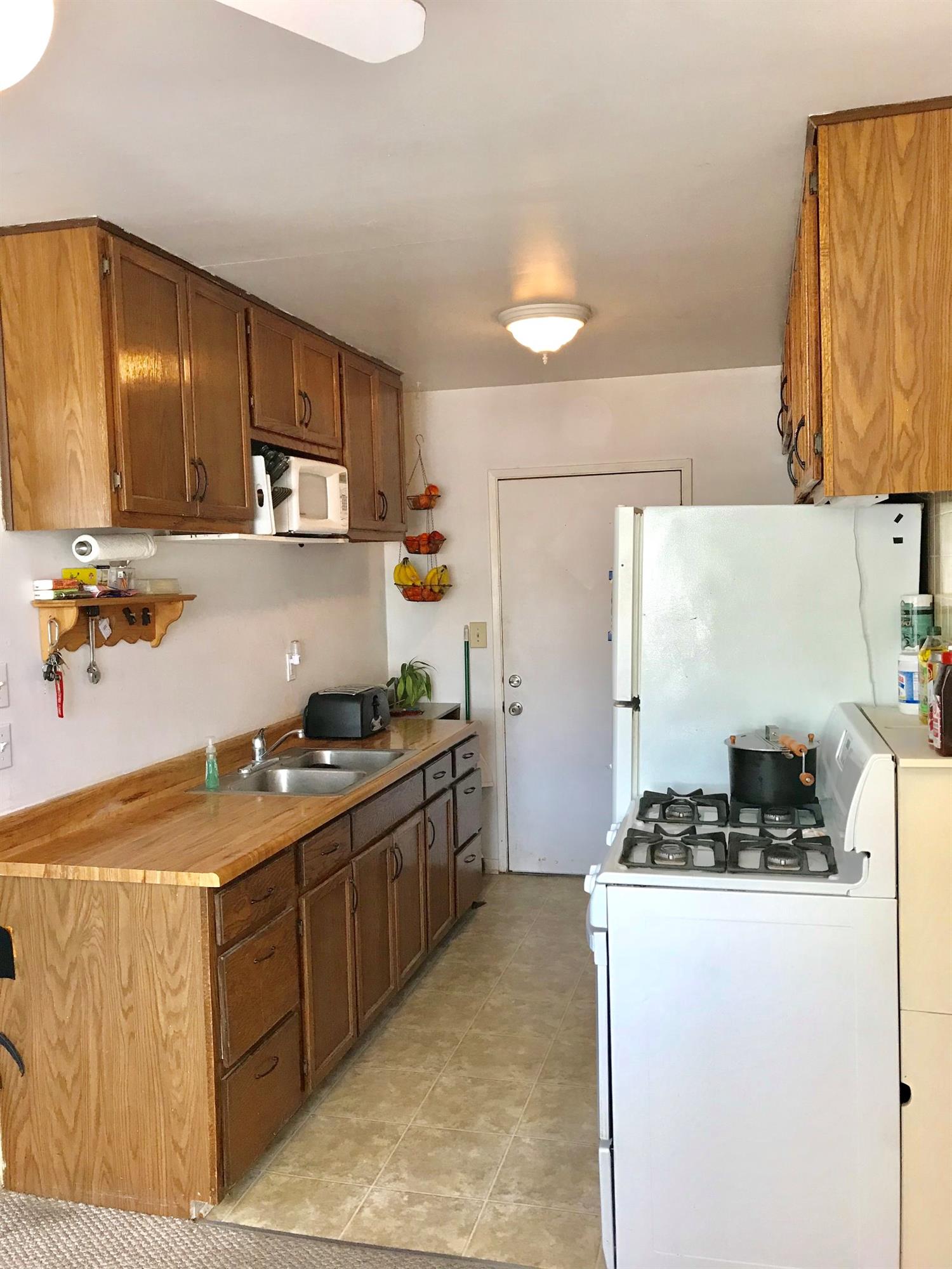 160 Grapevine Road Oak View, CA 93022 - Photo 9 of 35 a kitchen with a stove a sink and a refrigerator